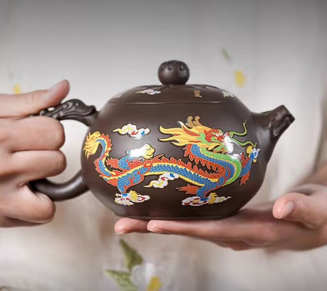 Hot water pouring over the purple clay teapot revealing the dragon shape