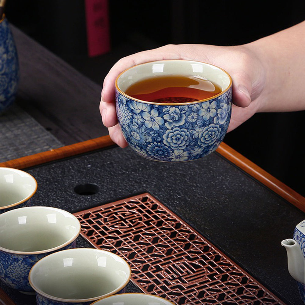 Close-up of the vibrant floral patterns on the luxury blue and white tea set, showcasing intricate craftsmanship.