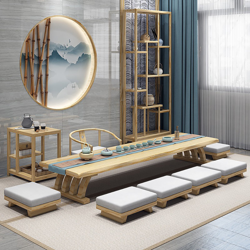 Elegant Japanese tea table set with guest chairs in a cozy living room setting.