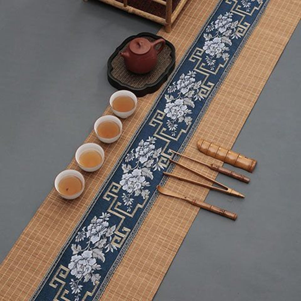 Close-up of bamboo tea mat with blue satin embroidery, ideal for home decor