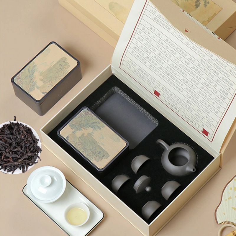 Dahongpao tea gift set with purple clay teapot and cups displayed elegantly on a wooden table.