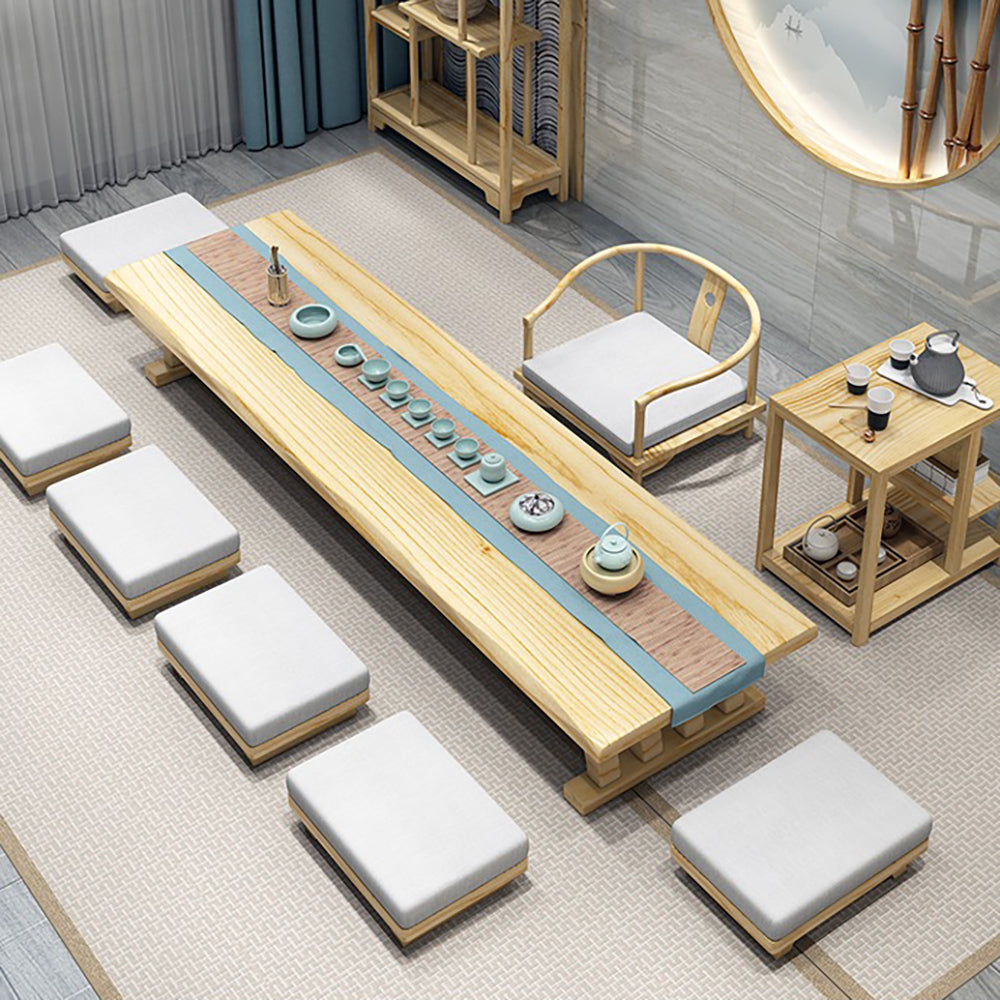 Elegant Japanese tea table set with guest chairs in a cozy living room setting.