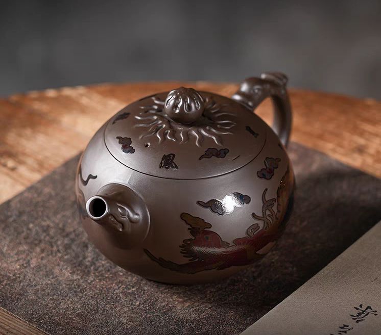 Close-up of the shiny, smooth surface of the purple clay dragon teapot