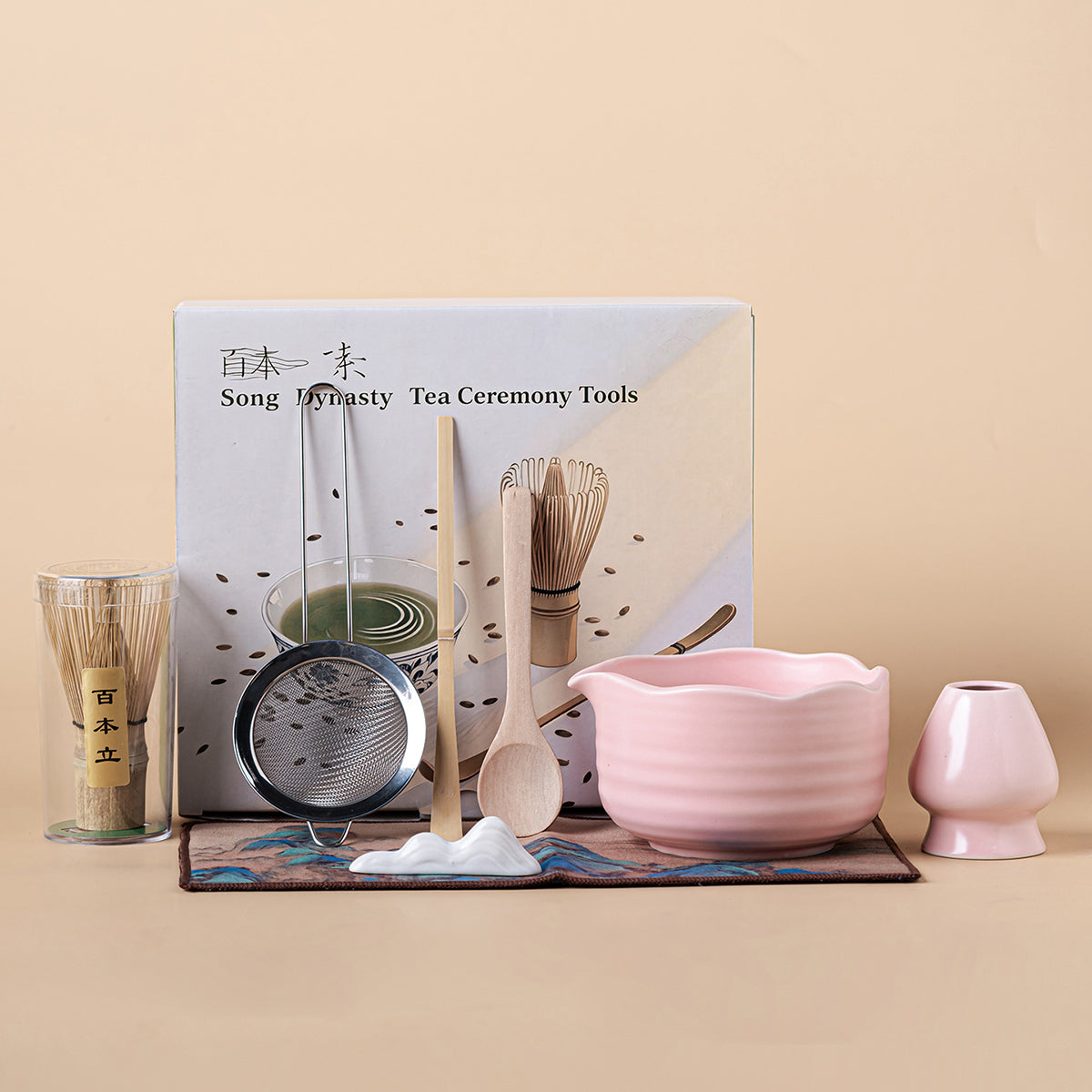 Elegant pink matcha tea set with a ceramic bowl and bamboo whisk, showcasing its unique design.