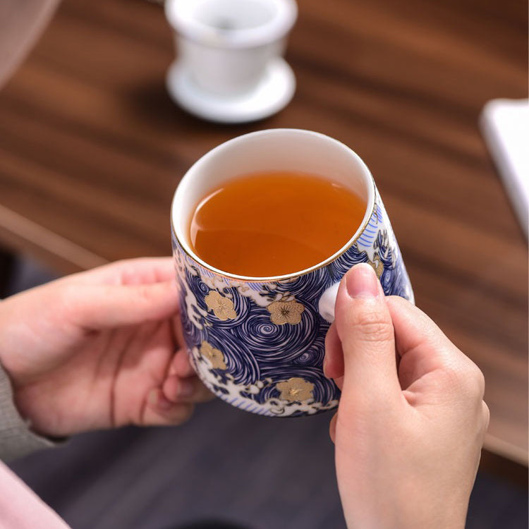Elegant Chinese Sea Wave Porcelain Tea Cup with Infuser showcasing waves and eddies design.