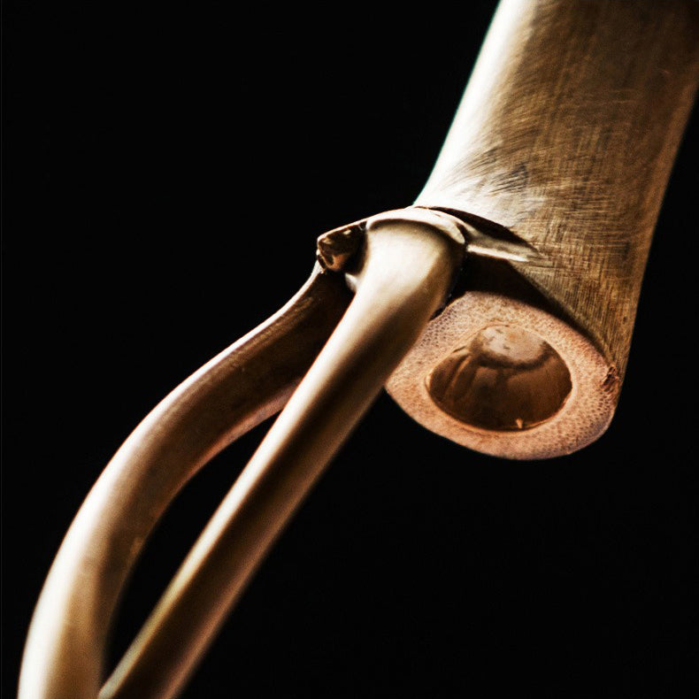 The bamboo teapot cleaning tool displayed next to a beautifully arranged tea set.