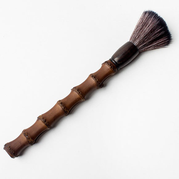 Close-up of eco-friendly bamboo teapot cleaning brush showcasing its unique design.