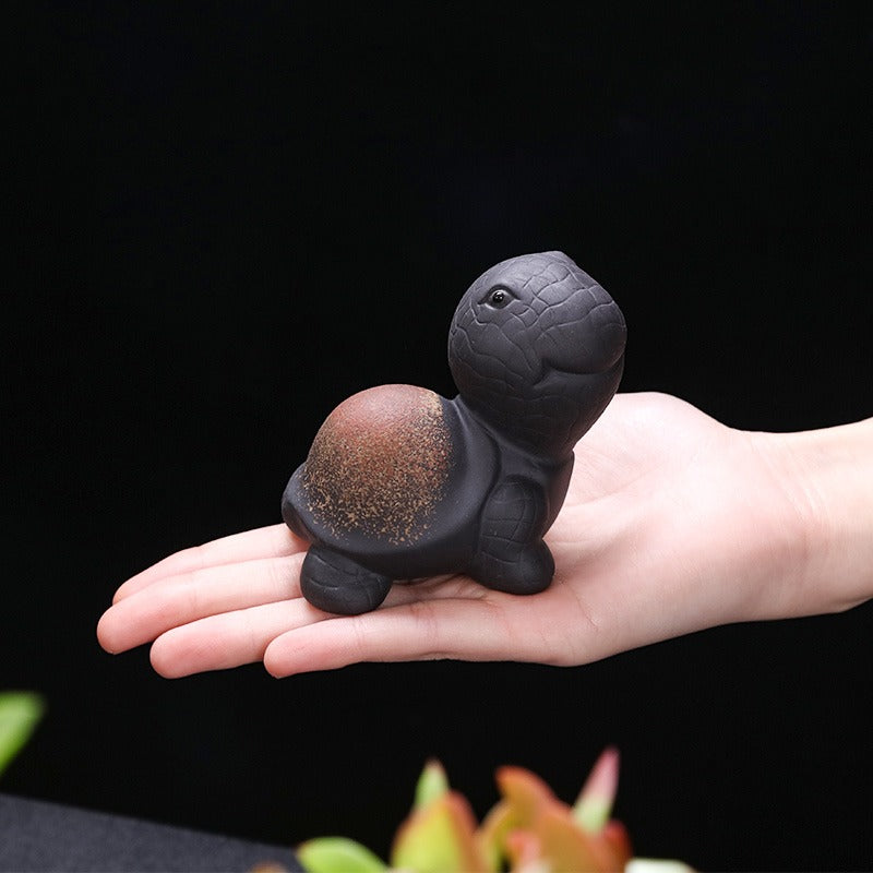 A side view of the Yixing Clay Tortoise Tea Pet during a tea ceremony, demonstrating its use in traditional tea practices.