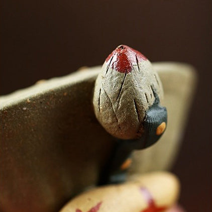 Yixing clay lotus seedpod water spray tea pet on tea tray, showcasing traditional craftsmanship