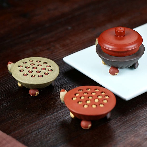 Yixing clay lotus seedpod water spray tea pet on tea tray, showcasing traditional craftsmanship