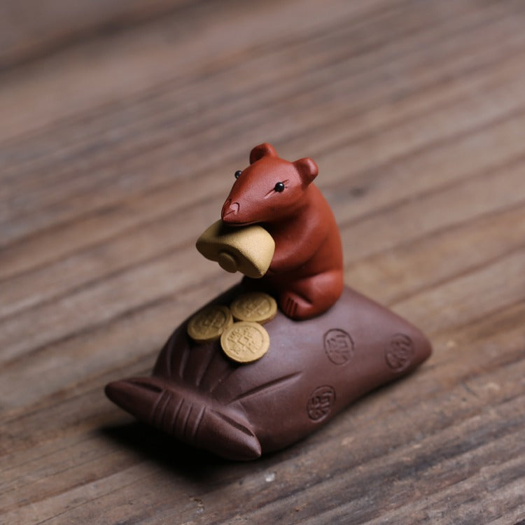 Tea pet on a tea tray, showcasing its role as a decorative and functional tea accessory