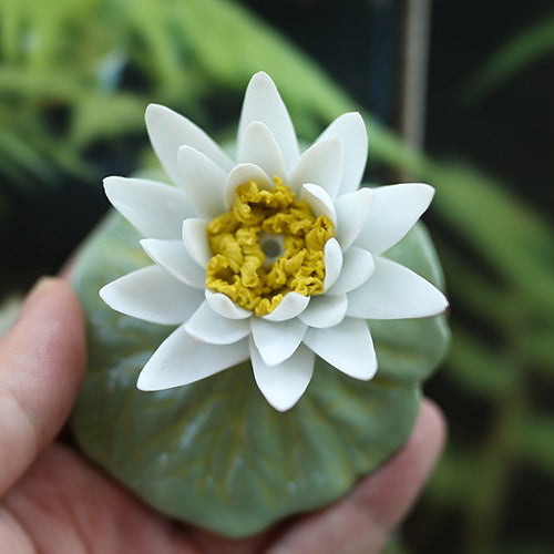 Close-up of a porcelain lotus flower tea pet with intricate details, ideal for tea lovers