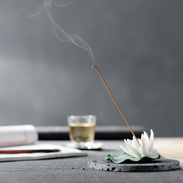 Tea lover arranging tea accessories with a handmade porcelain tea pet on the tea tray