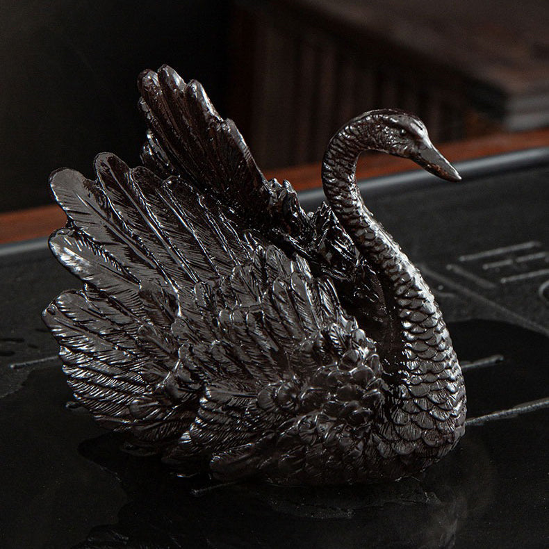Elegant swan tea pet set displayed on a traditional tea tray.