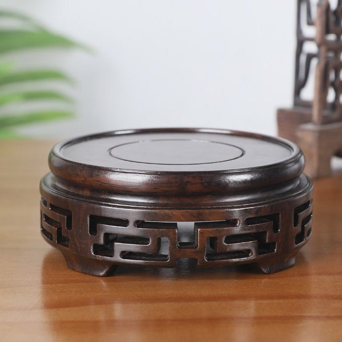 Teapot sitting on a stylish ebony wood stand, ideal for unique kitchen decor items