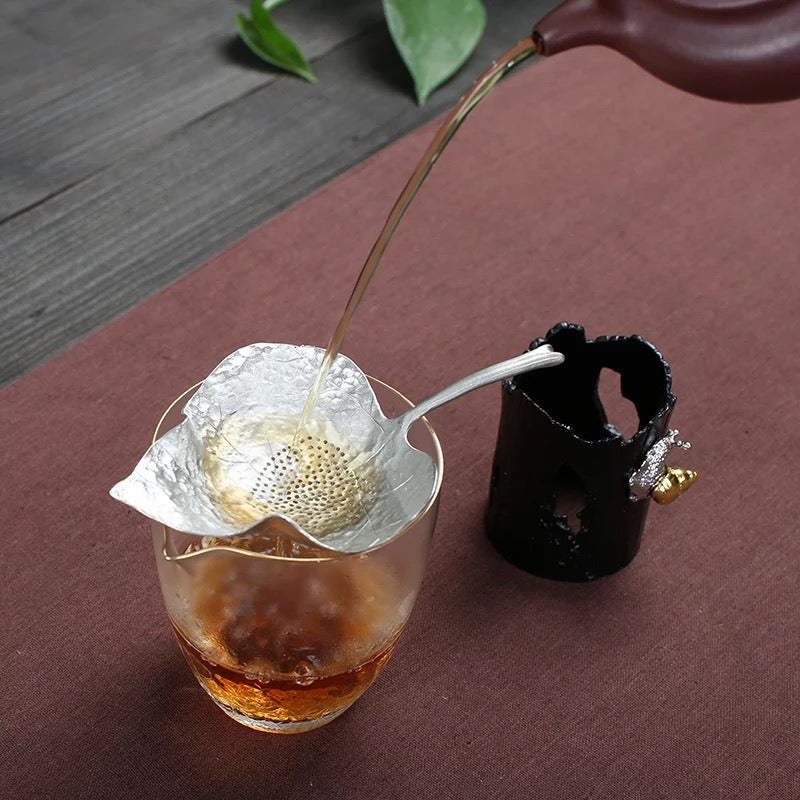 Close-up of Leaf Tin Tea Strainer with Holder showcasing its design and filter mesh