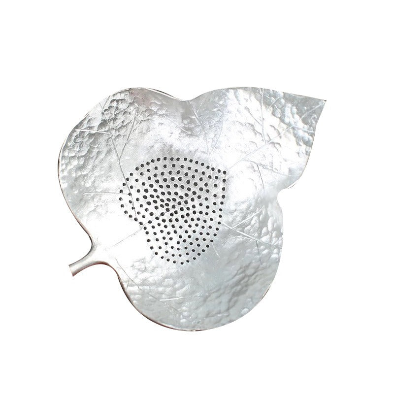 Using the tea strainer to pour brewed tea into a fair cup for clear tea experience