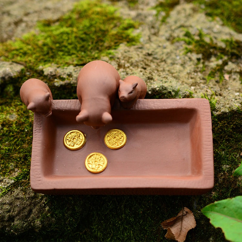 Close-up of Yixing clay piggy tea pets detailed craftsmanship