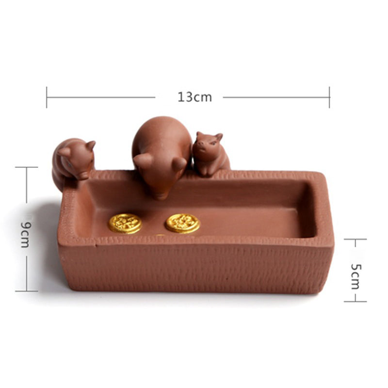 Close-up of Yixing clay piggy tea pets detailed craftsmanship