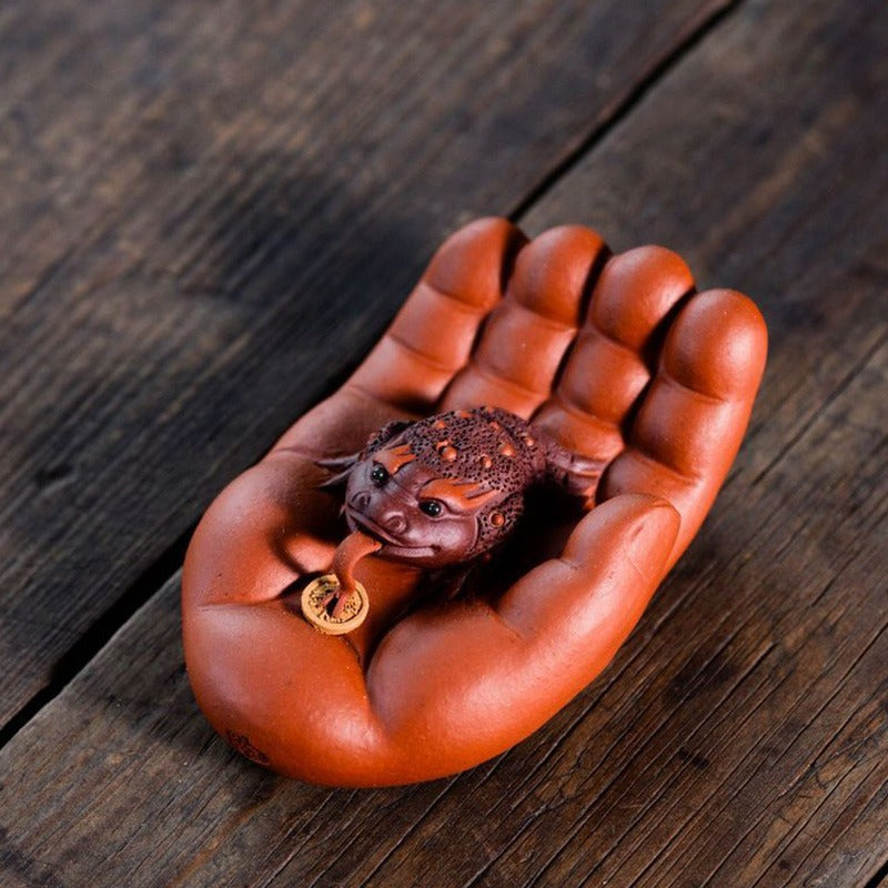 Beautifully glazed Yixing clay toad tea pet with a glossy surface, ideal for tea lovers
