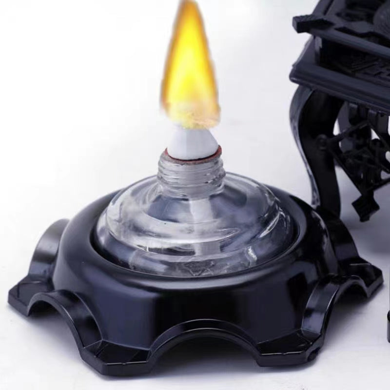 Close-up of the stainless steel stove heating tea, showcasing its design.