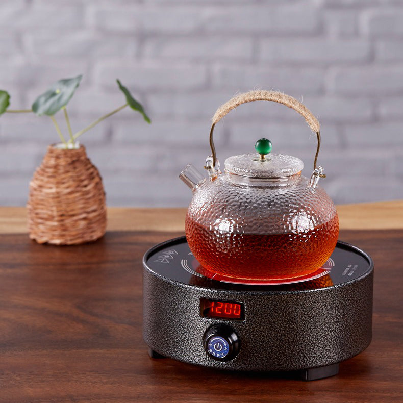 Tea enthusiast enjoying hot tea from a cast iron tea warmer