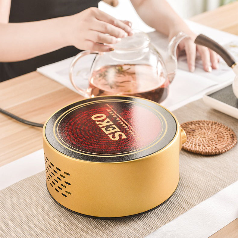 Close-up of stainless steel induction cooker tea warmer with a teapot on top