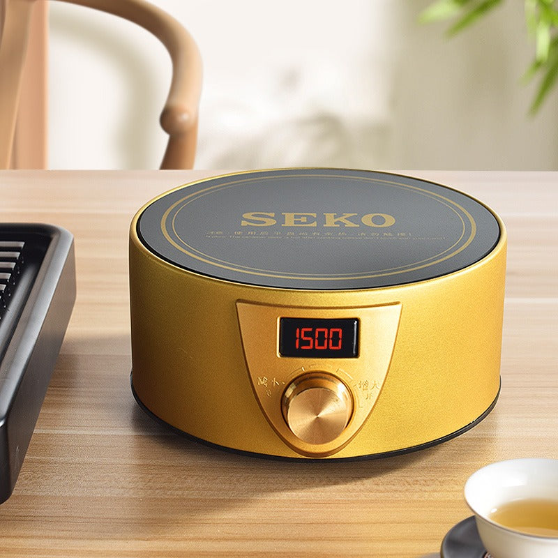 Tea being kept warm on an elegant electric teapot warmer in a cozy kitchen