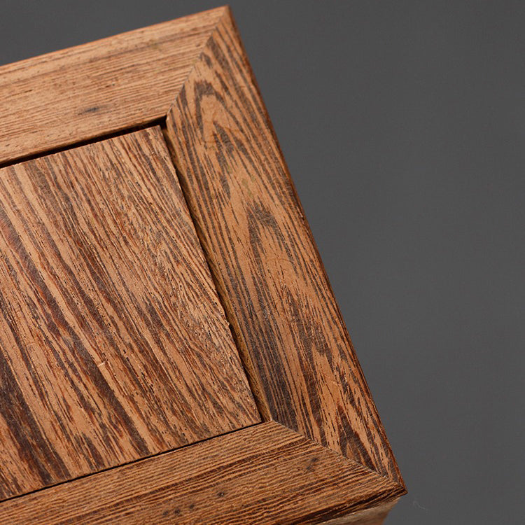 Elegant tea set displayed on the wooden teapot stand in a cozy kitchen setting