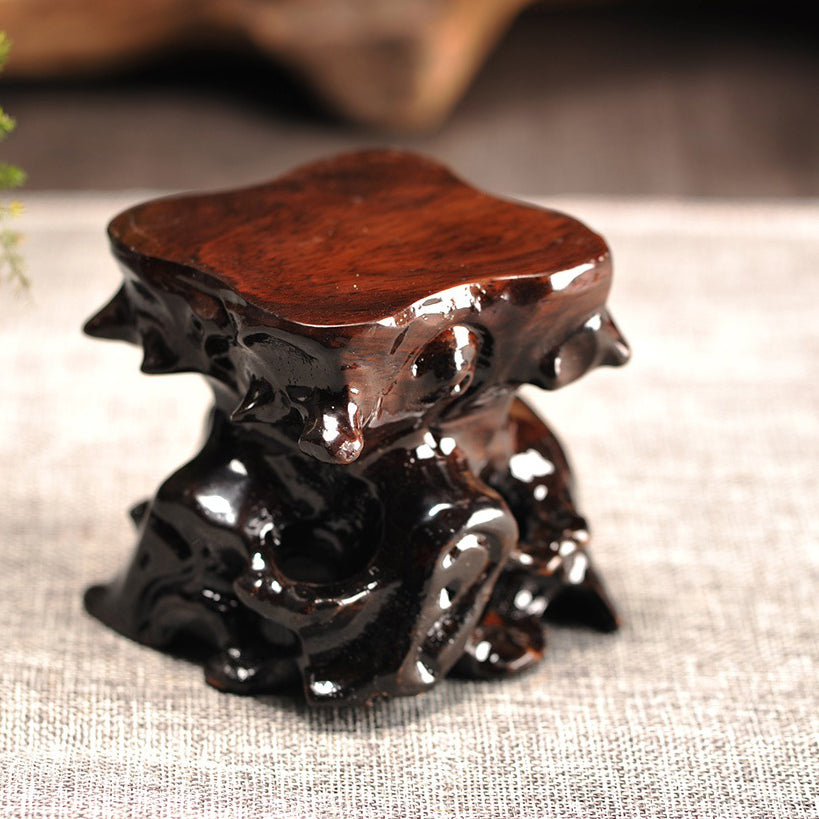 Elegant tea set display featuring artisan wooden teapot stand