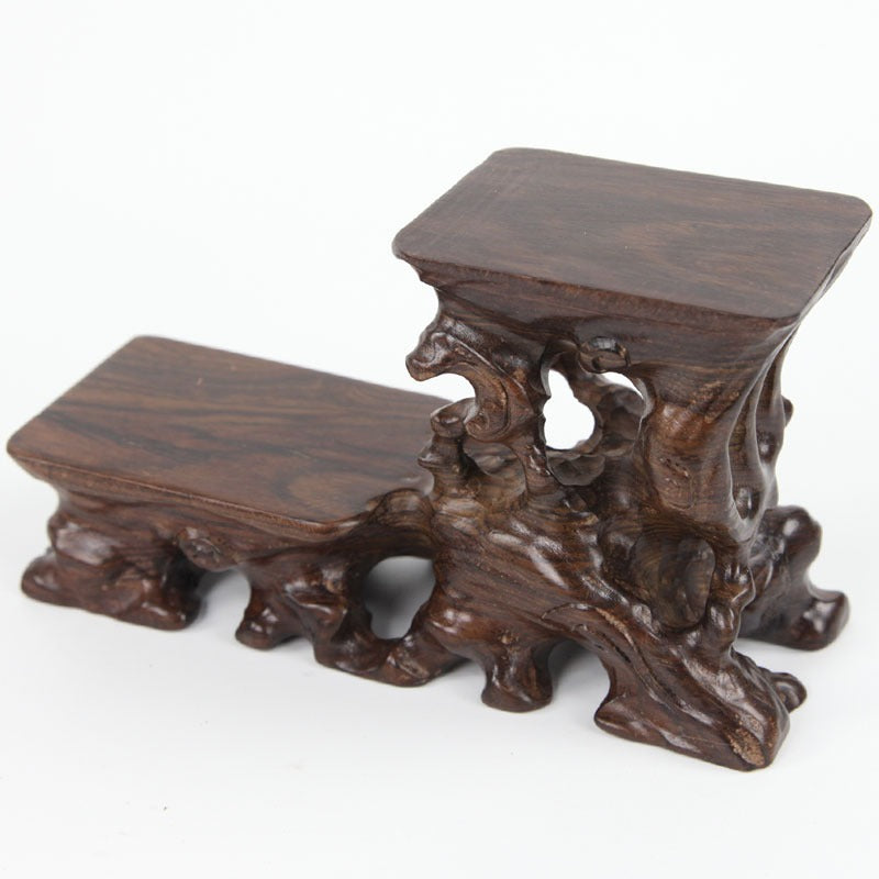 Stylish wooden teapot stand on a tea table, highlighting its artistic design