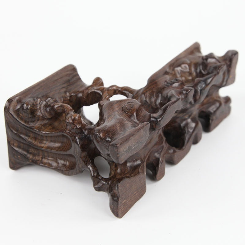 Artistic rosewood teapot stand with carved patterns, perfect for elegant tea service