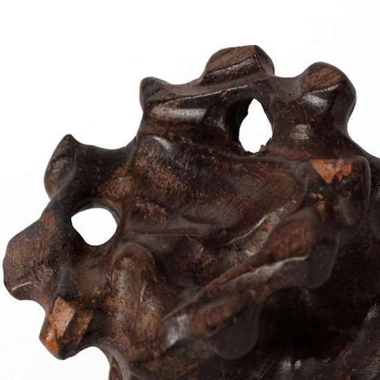 Elegant teapot stand from Pau preto wood placed on a tea tray as part of a traditional tea setting
