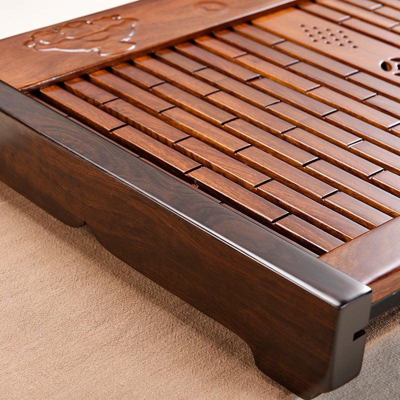 Rosewood tea tray in use during a quiet afternoon tea session with loose leaf setup