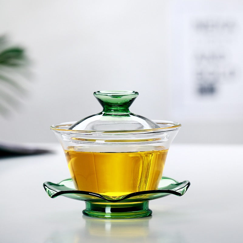 Tea brewing with a heat-resistant glass gaiwan, highlighting its sturdy build and transparency
