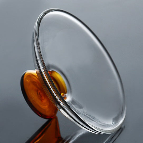 Using a gaiwan for tea brewing, pouring hot water into the glass gaiwan