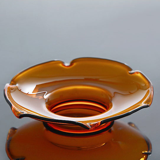 Tea brewing with a heat-resistant glass gaiwan, highlighting its sturdy build and transparency