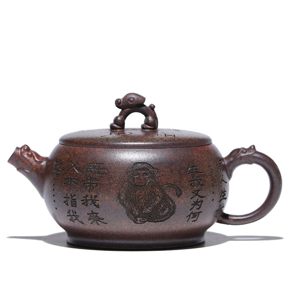 Close-up of handcrafted yixing purple clay monkey teapot showing detailed monkey sculpture on lid