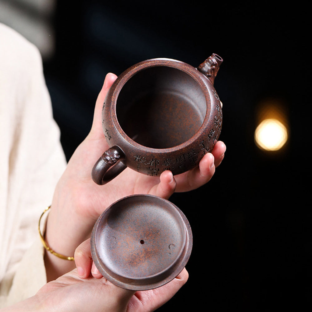 Side view of purple clay teapot highlighting sandy texture and elegant shape
