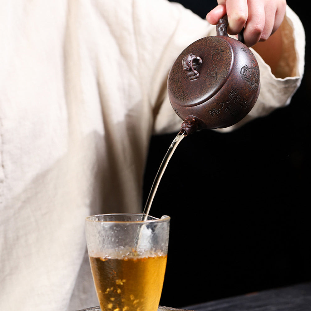 Tea pouring from the monkey teapot, showcasing smooth spout and functional design
