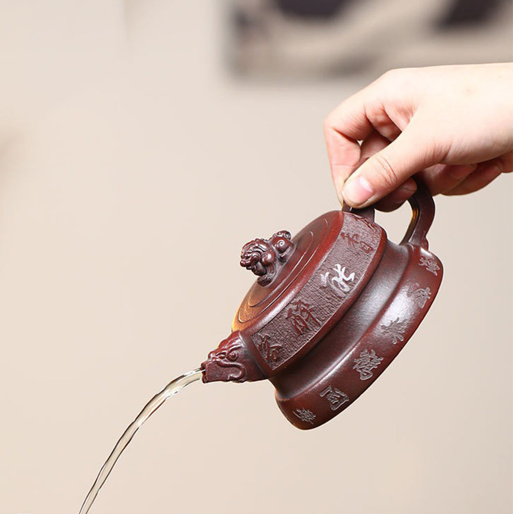 Front view of handcrafted Yixing purple clay lion teapot with detailed carvings