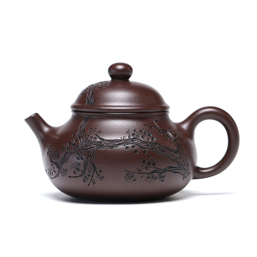 Close-up of the detailed plum blossom carving on the Yixing purple clay teapot