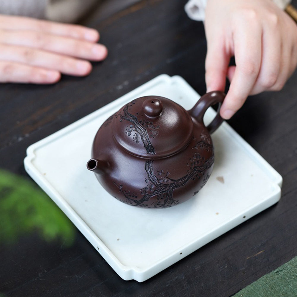 Yixing purple clay teapot in a traditional Chinese setting, ideal for tea brewing and gifting