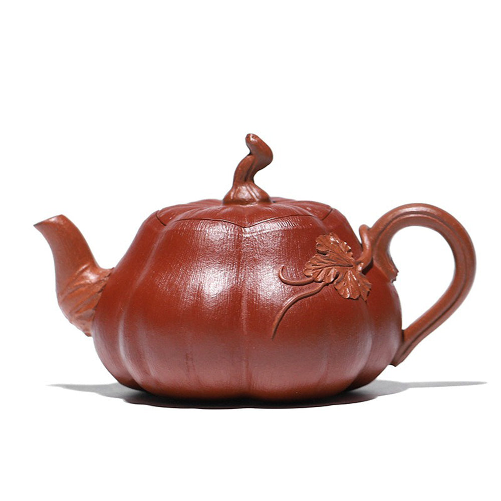 Handcrafted purple clay pumpkin teapot showcasing intricate vine details.