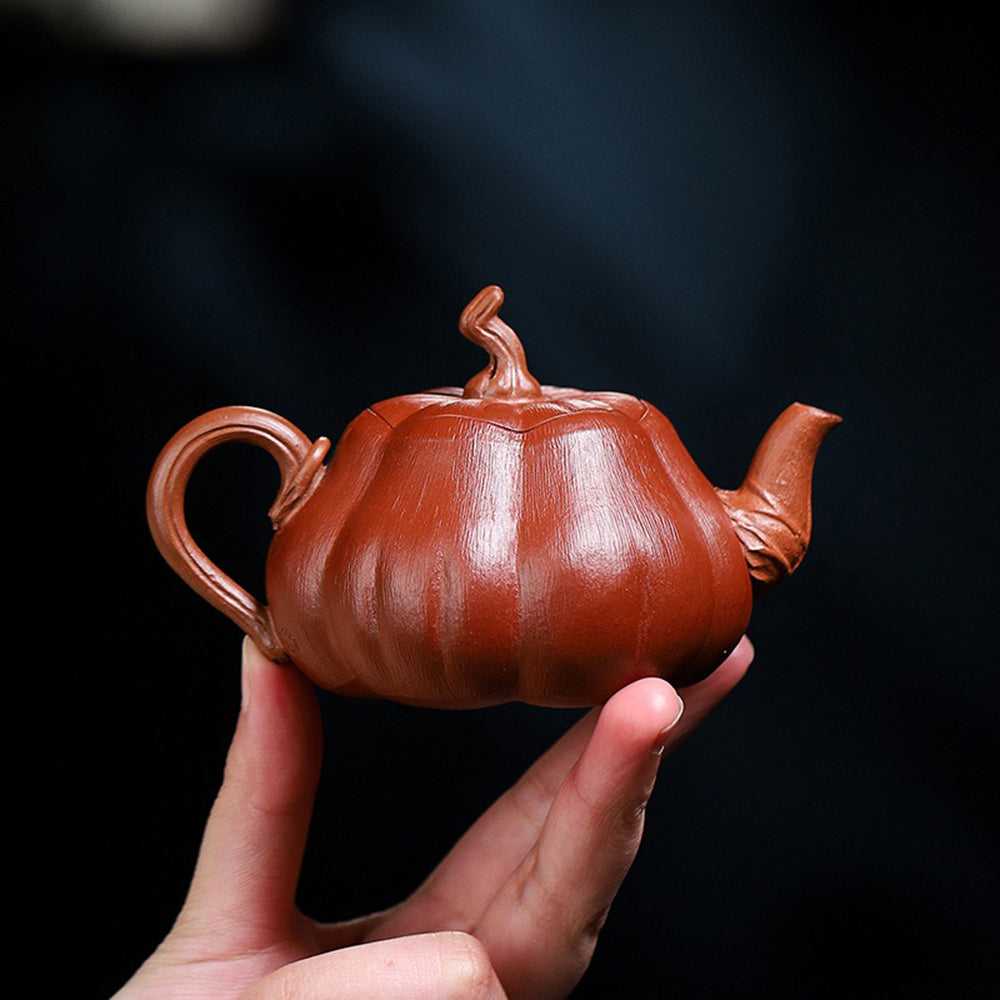 Lifelike pumpkin teapot with a detailed stem and smooth pouring spout.