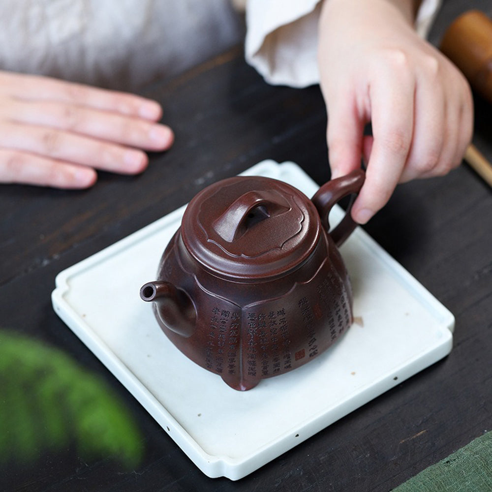 Front view of handcrafted purple clay lotus teapot with detailed carvings