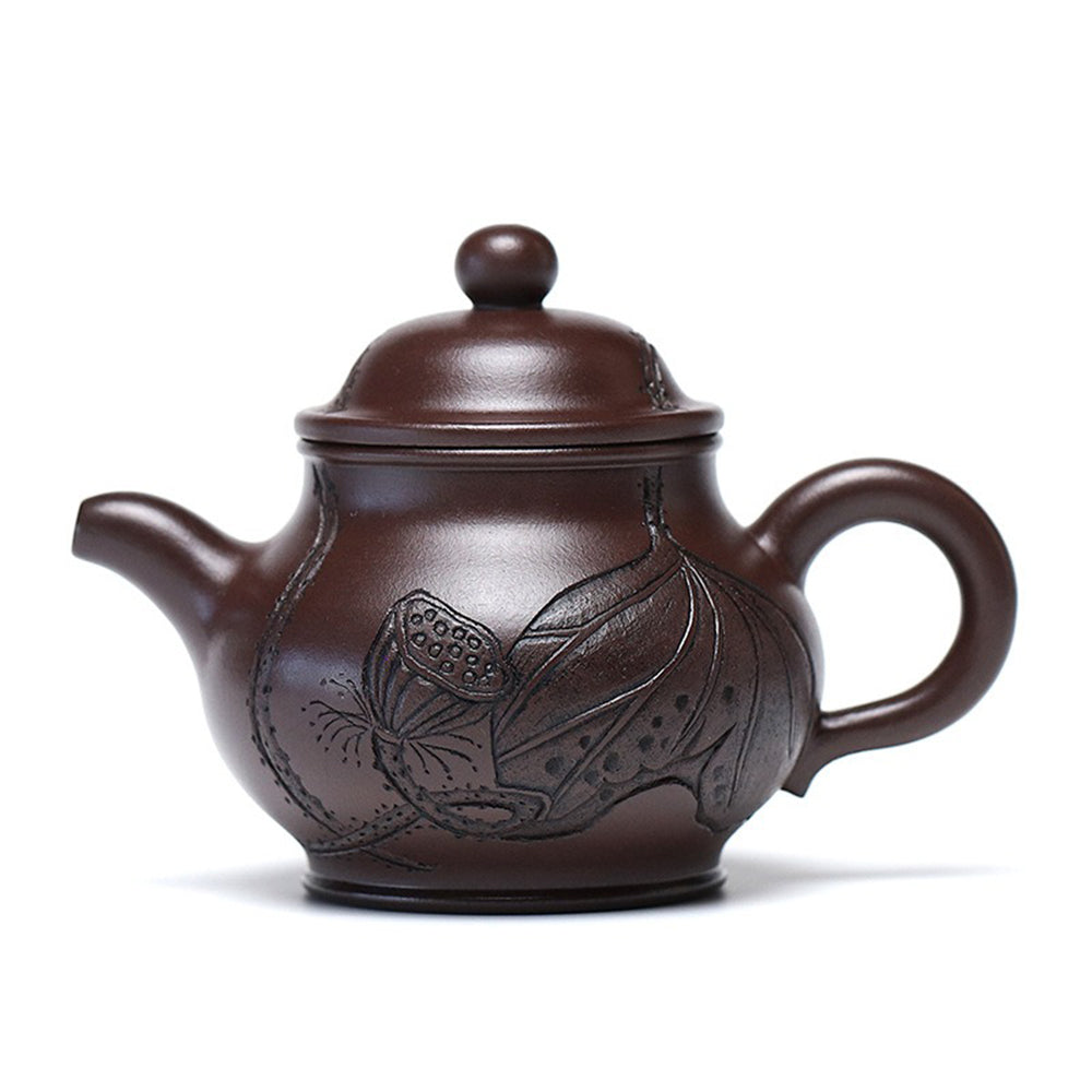 Yixing lotus teapot from an angled view, highlighting its elegant shape and lotus pattern.
