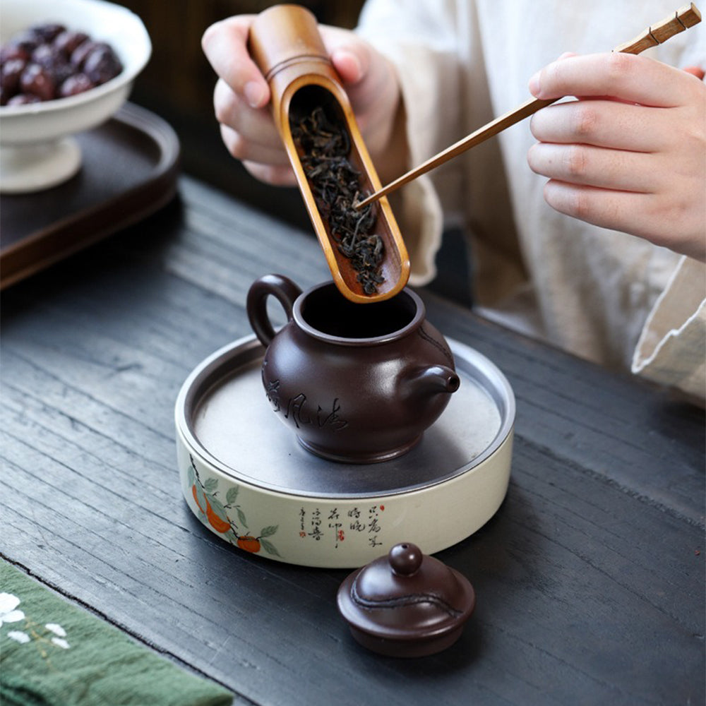 Close-up of the purple clay teapots spout and handle, showcasing the craftsmanship and usability.
