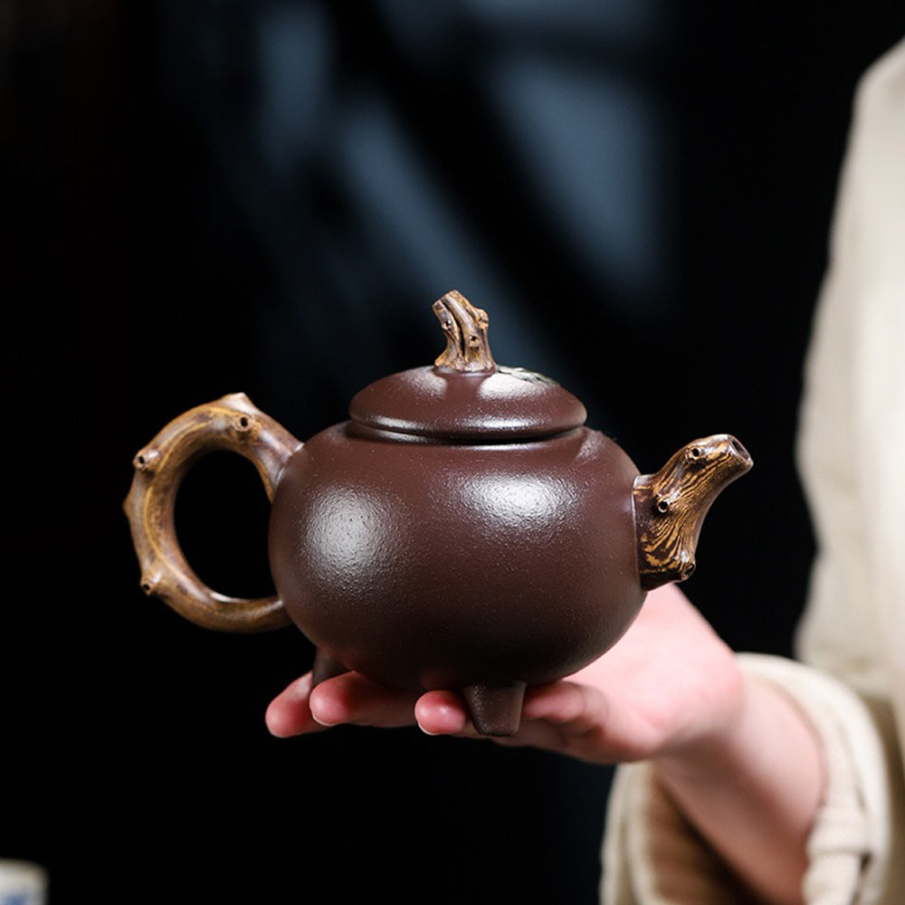 Elegant purple clay teapot with three-legged base and lid detail, perfect for gift giving
