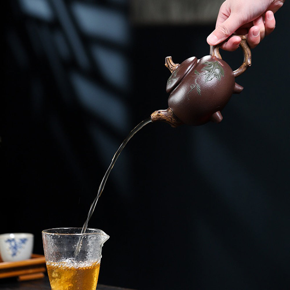 Handcrafted Yixing teapot with vine leaf detailing, ideal for tea ceremonies